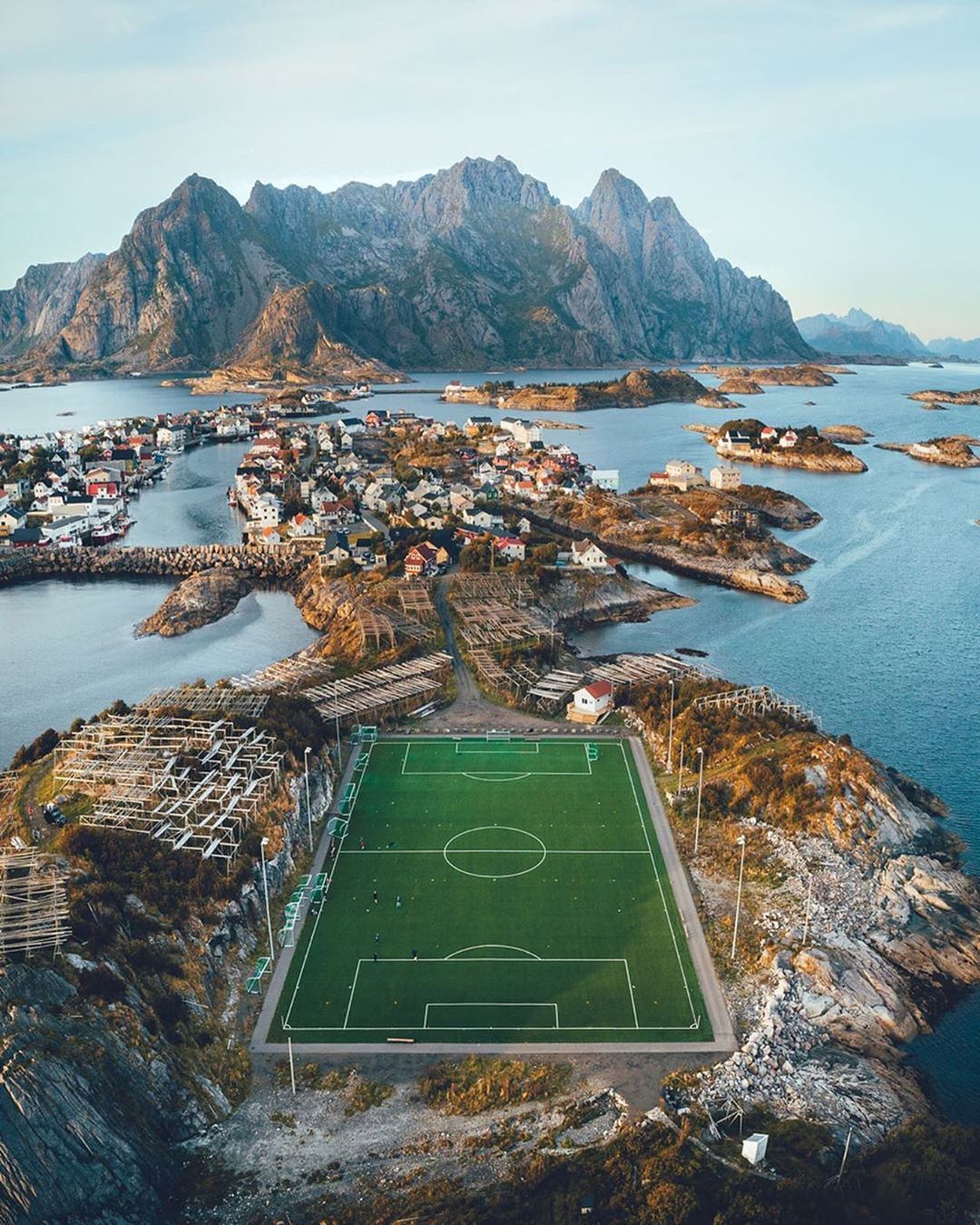 #HelloFrom Lofoten Islands, Norway. “This village is home to just 510 people, most of them fishermen,” says photographer Lennart Pagel (@lennart). “Instead of bleachers, the football [soccer] field is surrounded by wooden racks to dry fish.” ⁣
⁣
Photo by @lennart